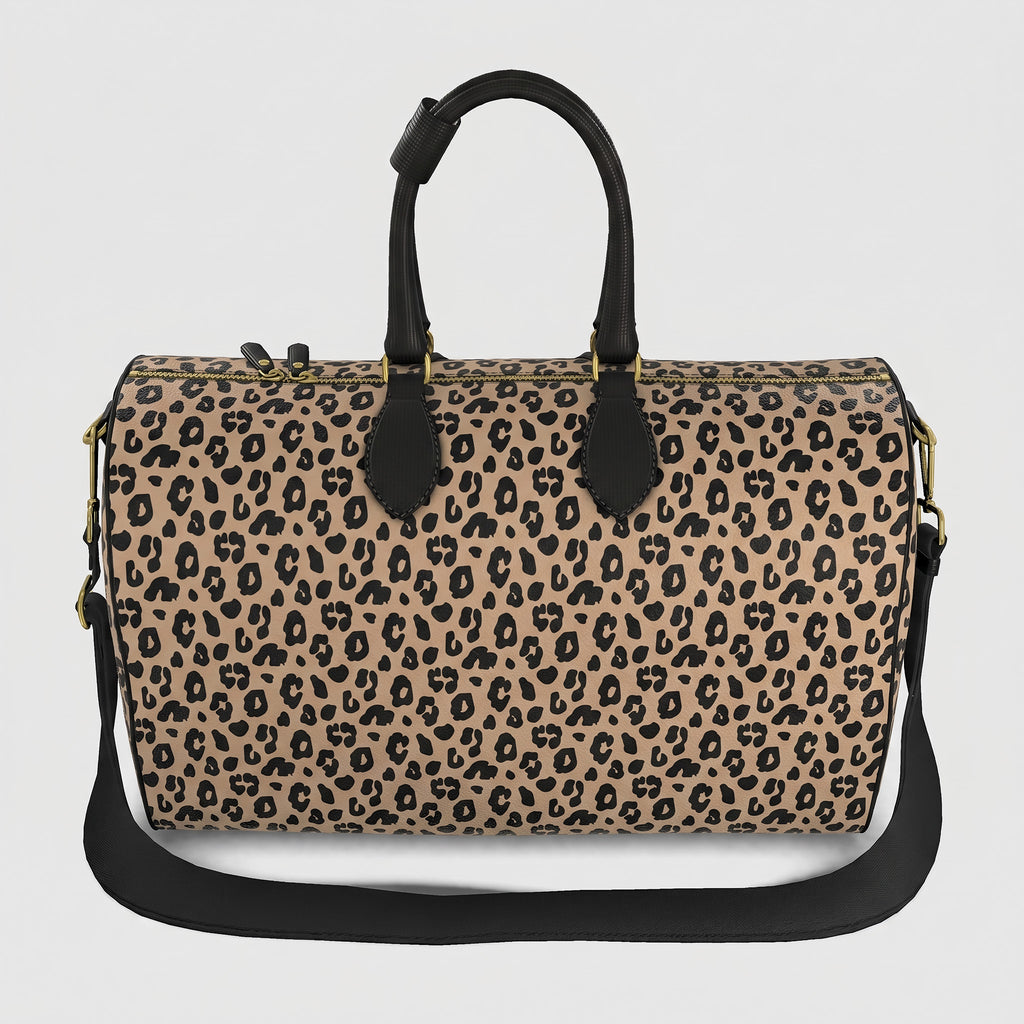 A Sahara leopard print large duffel bag with black handles, a black shoulder strap, and gold-tone hardware, shown against a light gray background.